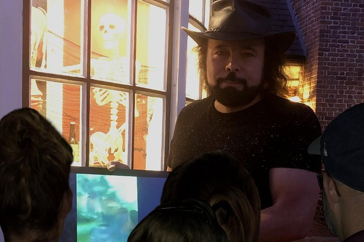 A tour group in Colonial Williamsburg's Merchants Square enjoying the Williamsburg West Tour; our guide showing the ghost photos on a Samsung Galaxy.